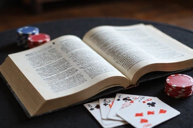 Open strategy guide book with playing cards